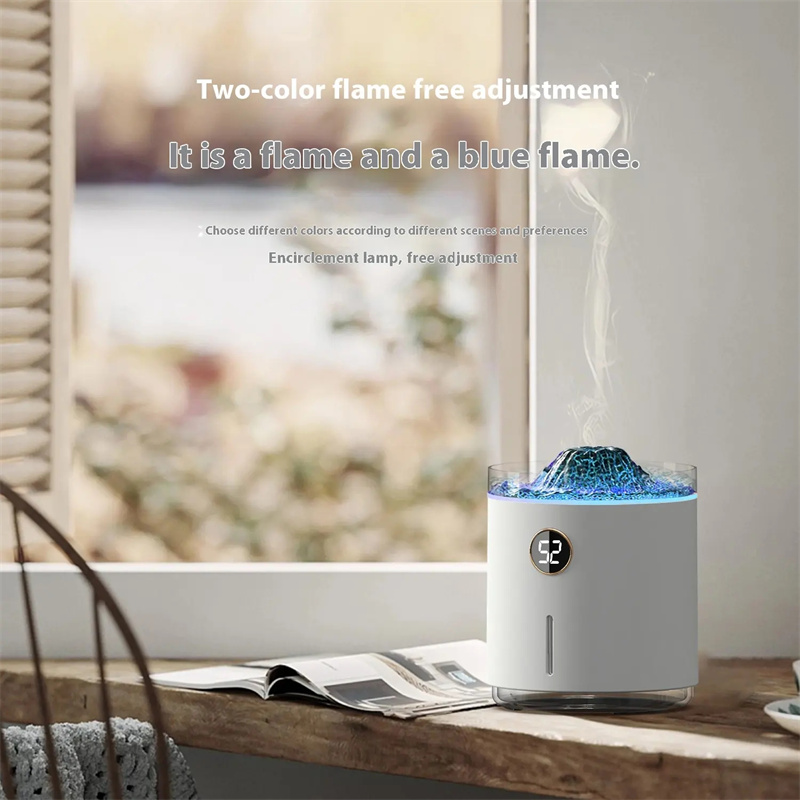 White Yminigo diffuser with a blue flame effect and digital battery display next to a window