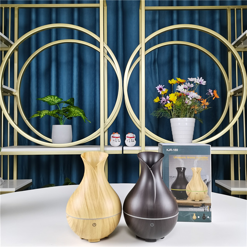 Yminigo KJR-169 vase humidifiers in light and dark wood finishes with their retail packaging box
