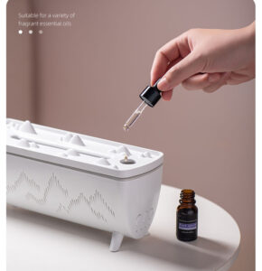 Adding fragrant essential oil with a dropper into the Yminigo V72 Yuanshan humidifier