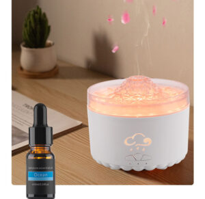 Yminigo V76B white volcano aroma diffuser with a glowing top, essential oil bottle, and floating petals