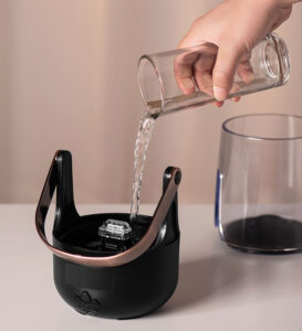 Pouring water into the 200ml tank of the Yminigo retro flame aroma diffuser