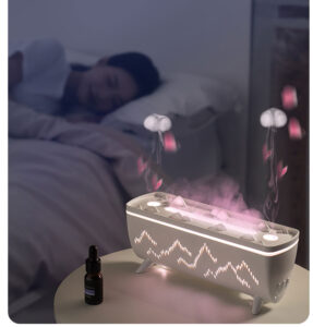 Yminigo V72 humidifier with pink jellyfish smoke rings on a nightstand next to a sleeping woman